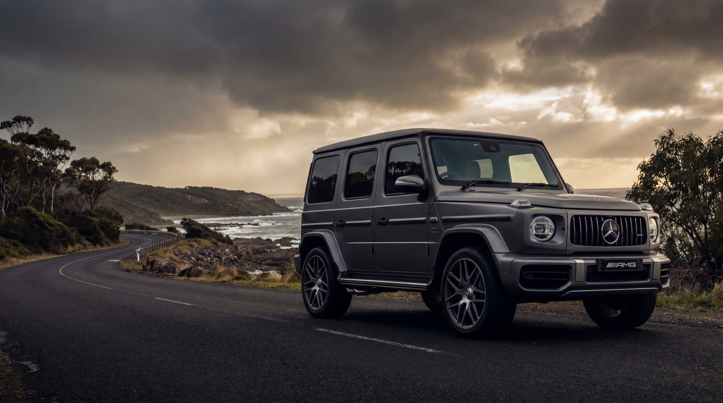 Mercedes-AMG G 63 on a coastal road under storm light